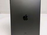 an apple ipad is sitting on a stand on a white surface