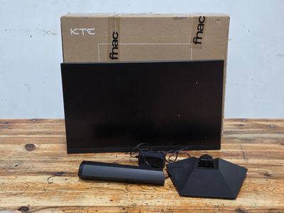 a computer monitor sitting on top of a wooden table next to a box