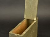 an old wooden box sitting on top of a black surface