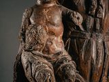 an old statue of a woman holding a child on her lap