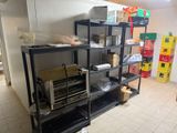 a kitchen with a stove, oven, and shelves in it