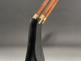 a pair of chopsticks sitting on top of a black case