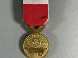 the medal is placed on a table with a red, white and blue ribbon