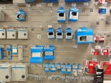 a wall of electronics for sale in a store