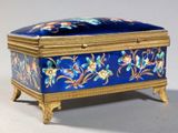 a blue and gold box with flowers on it