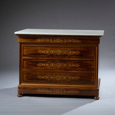 a small chest of drawers with a marble top
