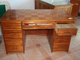 a wooden desk with two drawers on it in a kitchen