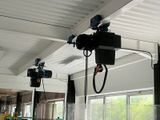 two lights that are hanging from the ceiling in the room