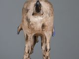 a small statue of a cow on a wooden table