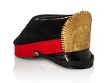 a black hat with a red band and a gold sun on it