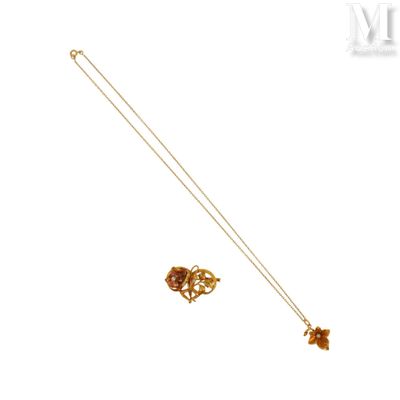 gold plated necklace and earrings with a flower design on a white background