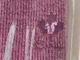 a pink sweater with a cat on it in a plastic bag