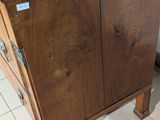 a wooden cabinet with a marble top on a tile floor