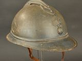 a silver helmet on a stand on a gray background