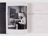 a book opened to show a black and white photo of a woman at a typewriter