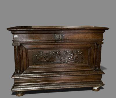 an old wooden chest with a carved design on the front