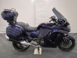 a blue motorcycle that is parked in a garage