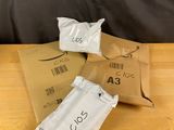three bags of food sitting on top of a wooden table