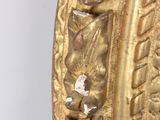 an image of a close up of a gold mirror on a white wall