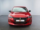 the front view of a red car parked in a showroom