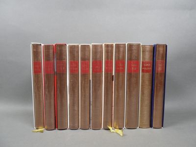 six books are lined up in a row on a gray surface