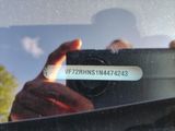 a man taking a picture of himself in the rear view mirror