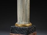 an image of a vase on a pedestal with a black background