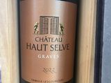 a bottle of wine sitting in a wooden box