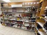 many shelves in the store that have various types of alcohol