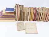 several books are stacked on top of each other on a white surface
