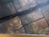 a broken glass window with a broken handle on it