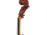 a close up of a violin on a stand with a white background
