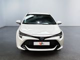 the front of a white toyota corollant parked in a room