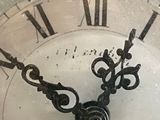a close up of a clock with roman numerals on it