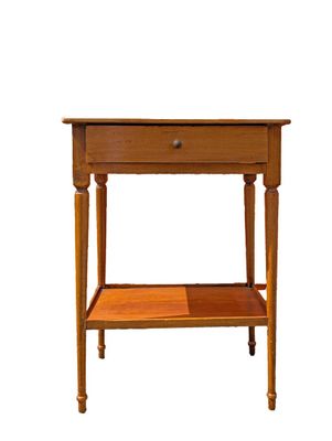a small wooden table with a drawer on it