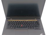 the laptop is open on a white surface with a black keyboard
