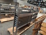 many metal shelves in a warehouse with wooden pallets on them