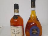 two bottles of cognac and a bottle of brandy on a table