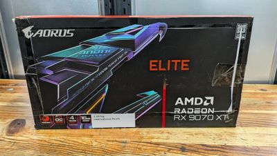 a box of amd radeon radeon elite gaming card on a wooden table