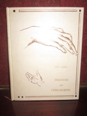 a white book with a drawing of a hand and a cat on it