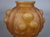 a yellow glass vase with a flower design on it