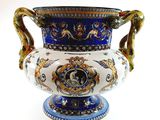 a blue and white vase sitting on a white surface