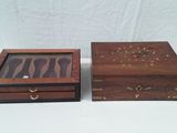two wooden boxes are sitting on a table with a wooden lid