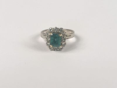 a close up of a ring with a green stone in it