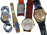 many different types of watches on display on a white surface