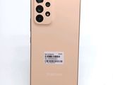 the back of a gold samsung galaxy s20 with a sticker on it