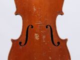 an old violin sitting on top of a wooden stand