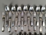 a lot of silver spoons and forks on the table