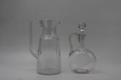two glass jugs sitting next to each other on a table