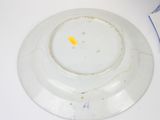a white plate with a yellow spot on it
